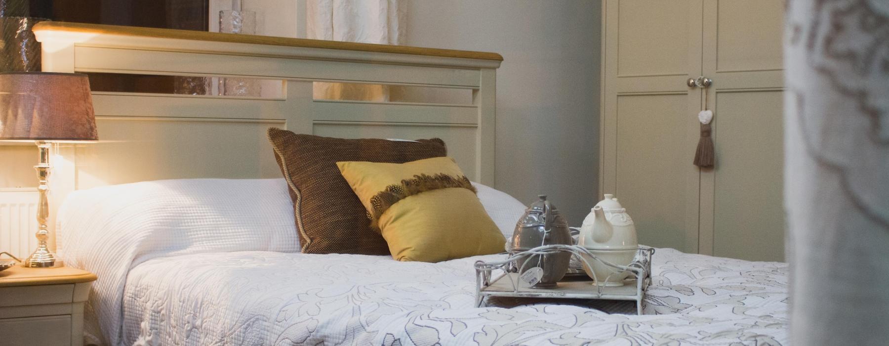 a bed with a white bed spread